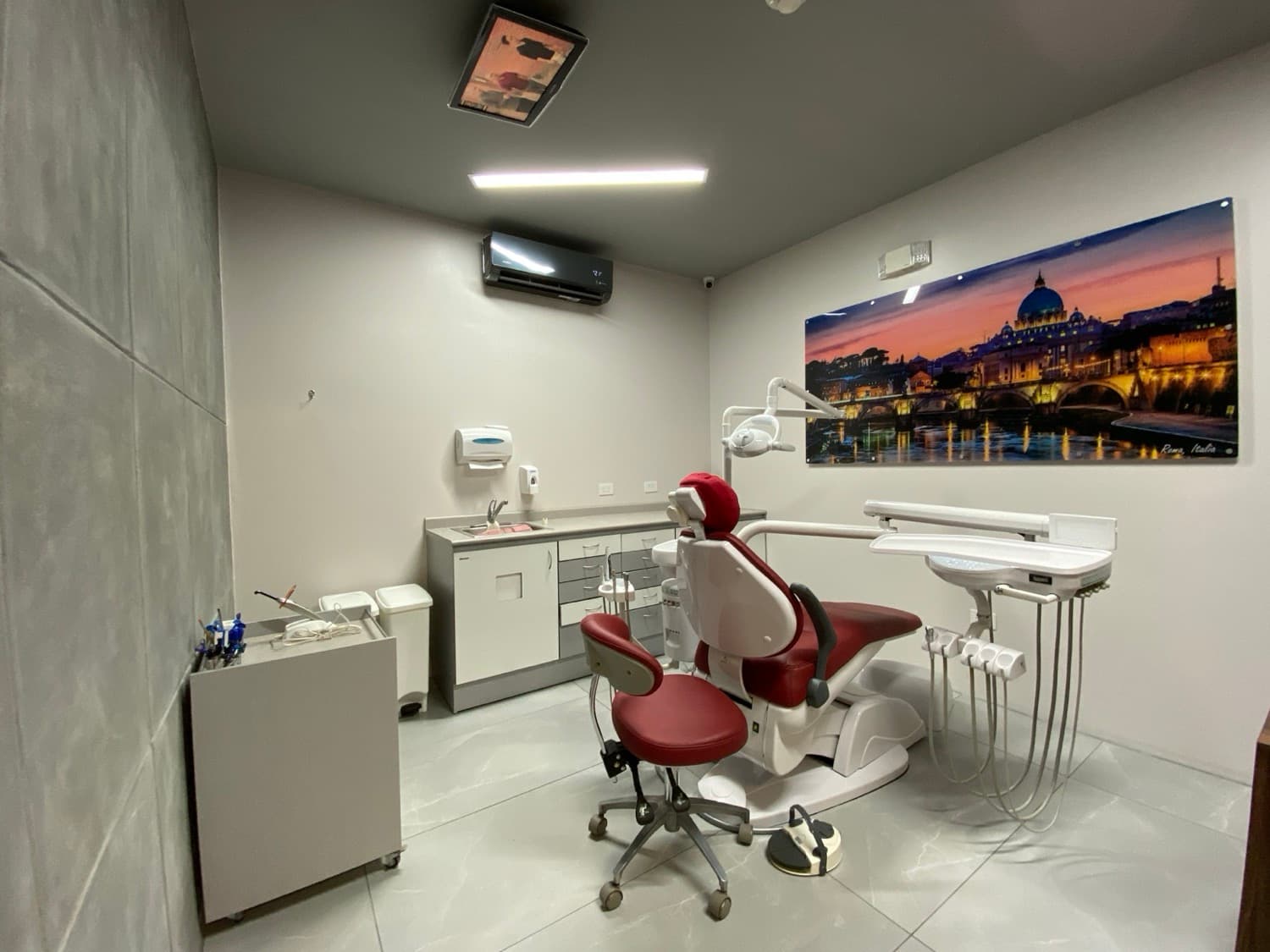 Treatment room with dental chair and scenic wall art