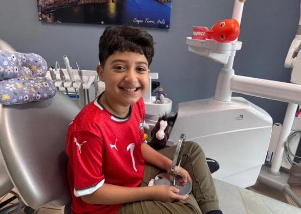 Happy boy smiling in the dental chair